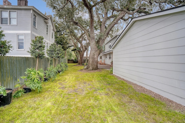 view of yard with fence and a wooden deck