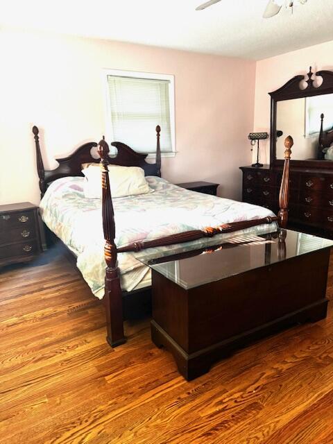 bedroom with ceiling fan and hardwood / wood-style flooring