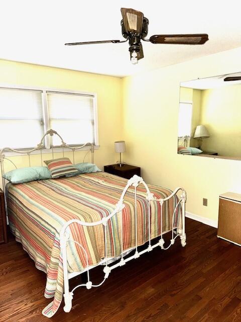 bedroom featuring dark hardwood / wood-style flooring and ceiling fan