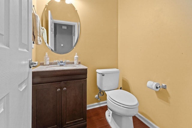 5404 Red Fork Ln, North Charleston, SC 29420 - bathroom with toilet, baseboards, wood finished floors, and vanity