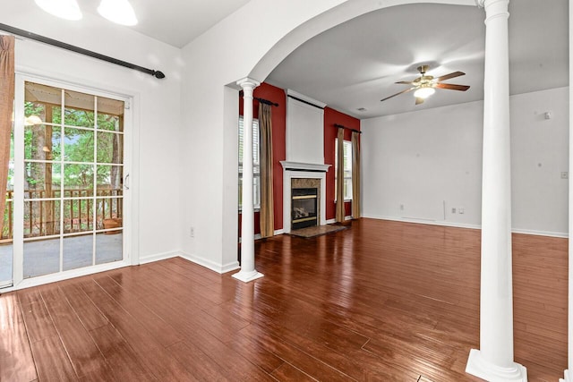 5404 Red Fork Ln, North Charleston, SC 29420 - unfurnished living room with decorative columns, ceiling fan, wood finished floors, a premium fireplace, and arched walkways