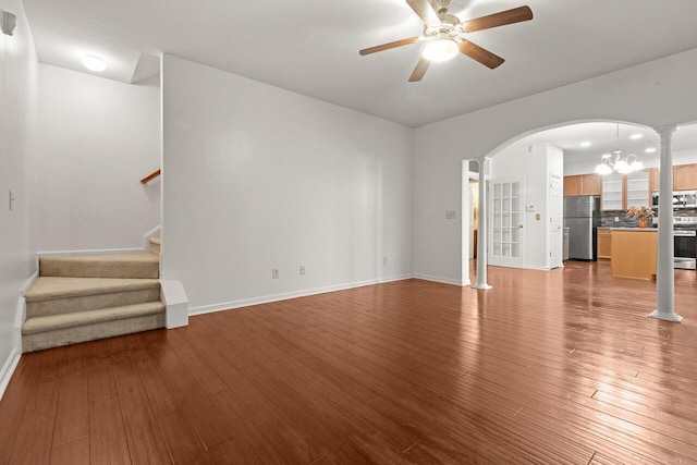 5404 Red Fork Ln, North Charleston, SC 29420 - unfurnished living room featuring a chandelier, wood finished floors, a ceiling fan, arched walkways, and baseboards