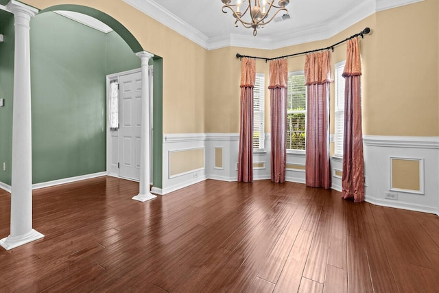 5404 Red Fork Ln, North Charleston, SC 29420 - empty room with decorative columns, arched walkways, wood finished floors, wainscoting, and ornamental molding