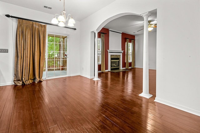 5404 Red Fork Ln, North Charleston, SC 29420 - unfurnished dining area with ornate columns, arched walkways, hardwood / wood-style flooring, a fireplace with flush hearth, and ceiling fan