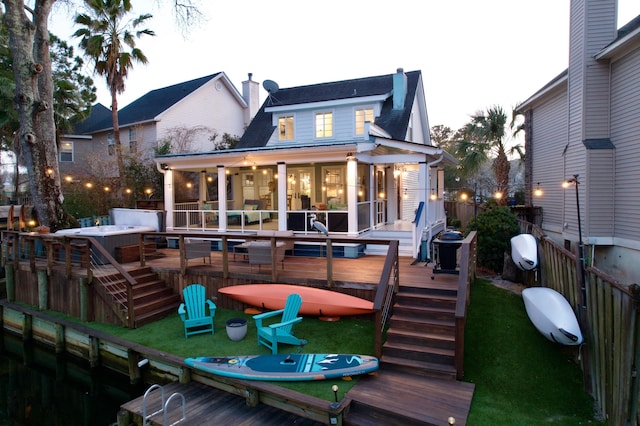 back of house featuring fence, a chimney, and a wooden deck