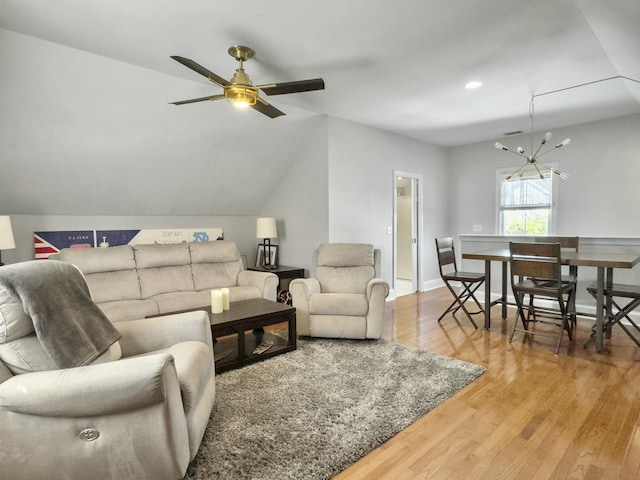 living area with ceiling fan, baseboards, wood finished floors, and vaulted ceiling