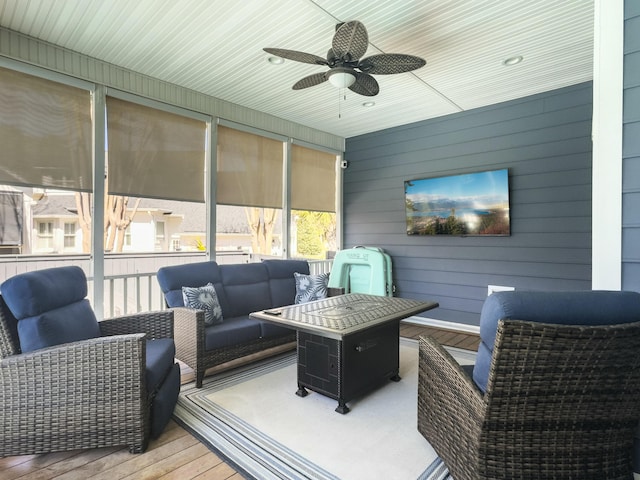 sunroom / solarium with a ceiling fan