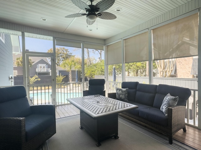 sunroom / solarium with plenty of natural light and ceiling fan