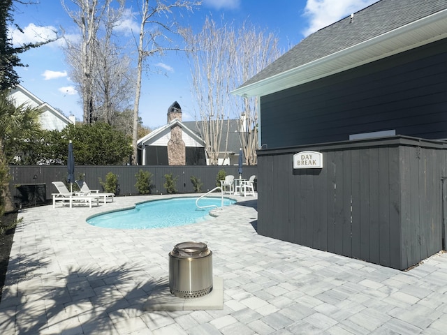 view of swimming pool with a patio, fence, and a fenced in pool