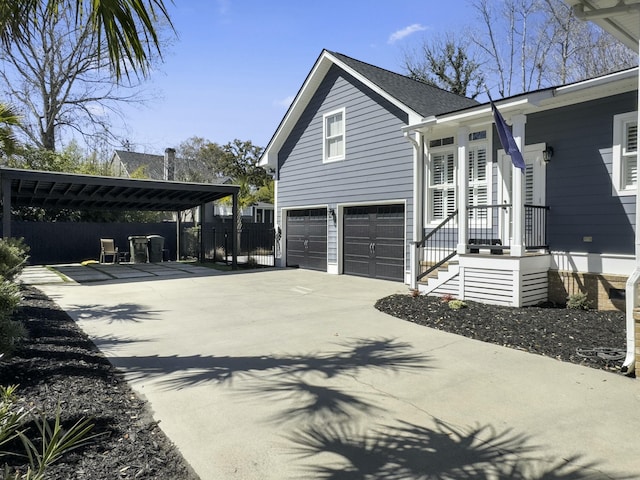 view of home's exterior with a carport, a garage, and driveway