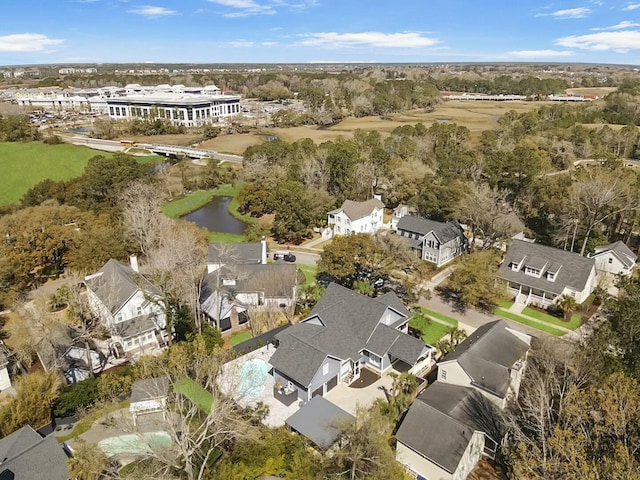 drone / aerial view featuring a residential view and a water view