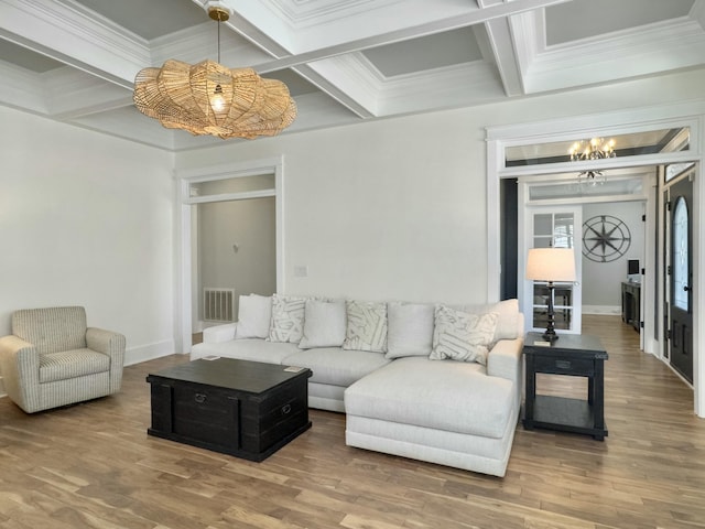 living area with beam ceiling, visible vents, coffered ceiling, and wood finished floors