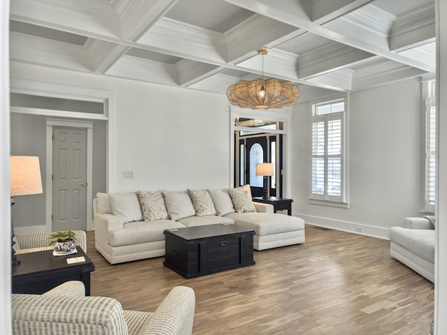 living room featuring beamed ceiling, baseboards, wood finished floors, and ornamental molding