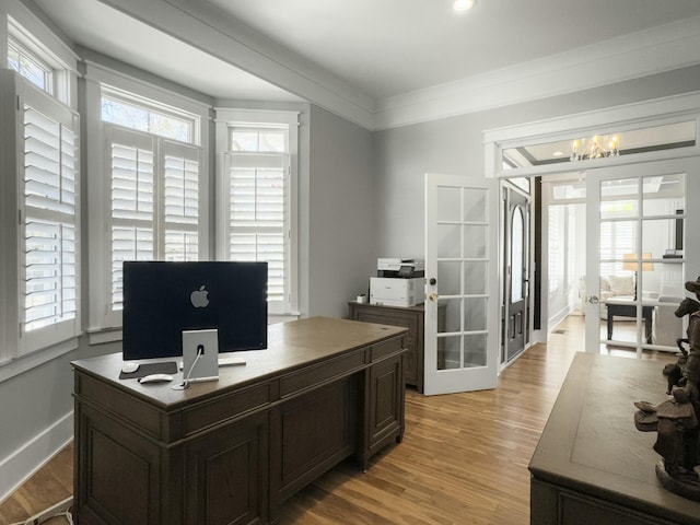 home office featuring a wealth of natural light, light wood-style flooring, french doors, and crown molding