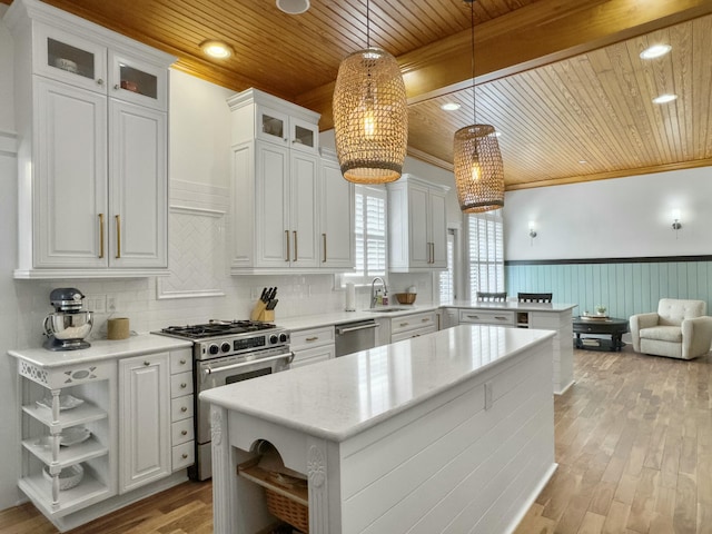 kitchen with appliances with stainless steel finishes, wooden ceiling, a peninsula, and open shelves