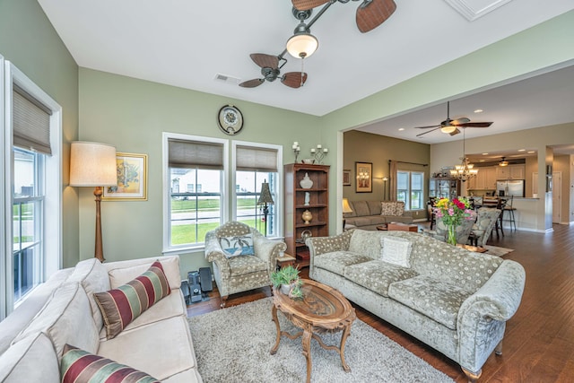 511 Nandina Dr, Goose Creek, SC 29445 - living room featuring ceiling fan with notable chandelier, dark wood-type flooring, and visible vents
