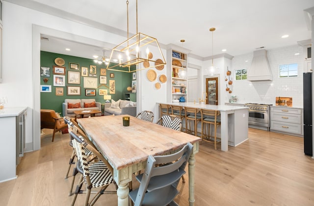 dining room featuring light wood-style floors and recessed lighting