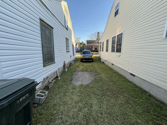 view of home's exterior with crawl space and a lawn