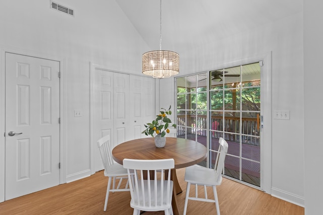 1441 Waterside Ct, Mount Pleasant, SC 29464 - dining space featuring a chandelier, high vaulted ceiling, and wood finished floors