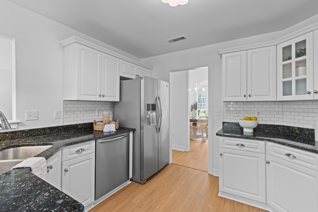 1441 Waterside Ct, Mount Pleasant, SC 29464 - kitchen featuring stainless steel appliances, light wood-style flooring, white cabinets, and glass insert cabinets