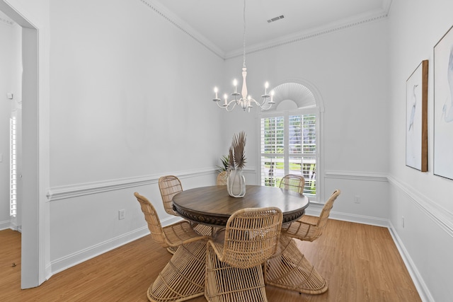 1441 Waterside Ct, Mount Pleasant, SC 29464 - dining area with a chandelier, wood finished floors, and ornamental molding