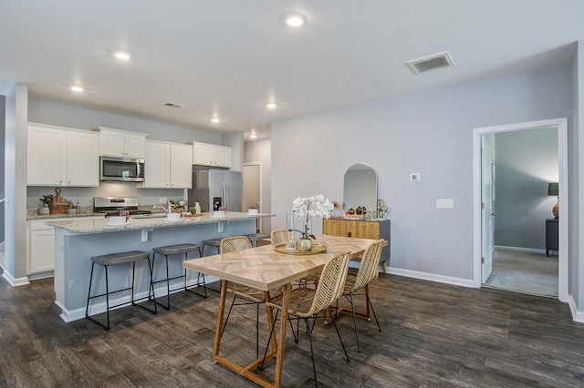 dining space featuring dark hardwood / wood-style floors