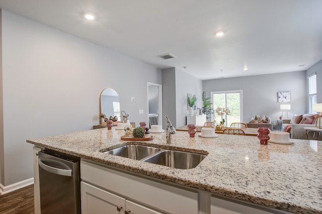 kitchen with light stone counters, dark hardwood / wood-style floors, and sink