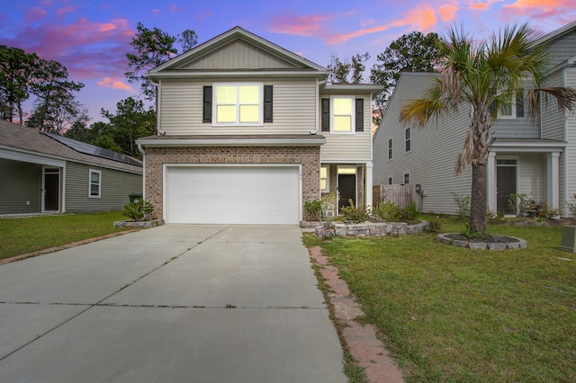 view of front of house featuring a lawn and a garage