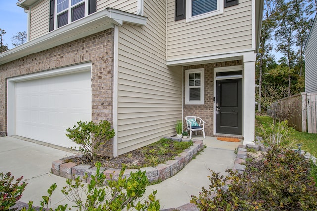 view of exterior entry with a garage