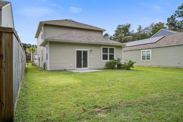 back of property featuring a yard and a patio