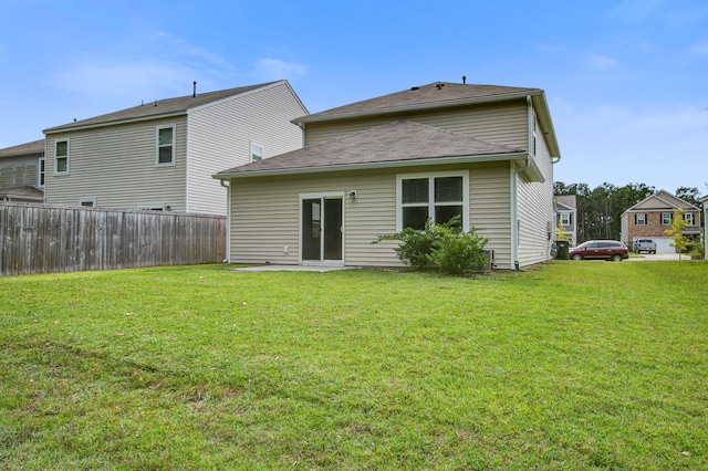 rear view of property with a lawn