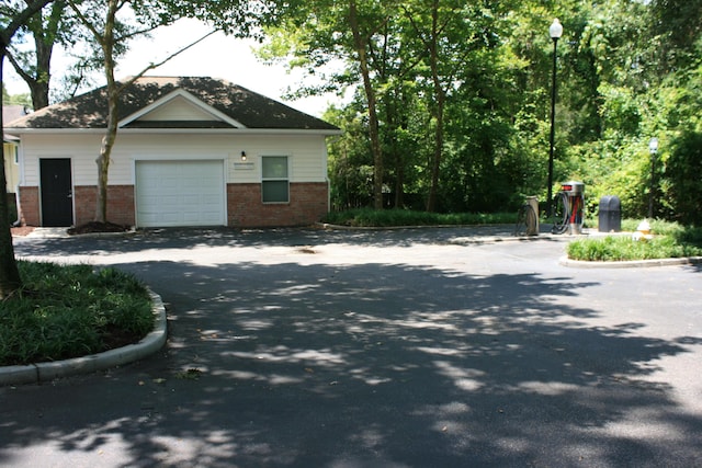 1755 Central Park Rd Unit 9103, Charleston, SC 29412 - view of side of property featuring brick siding, driveway, a garage, and an outdoor structure