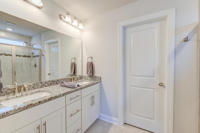 bathroom with walk in shower, tile patterned floors, and vanity