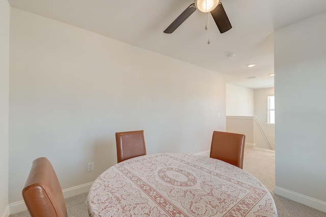 dining area featuring light colored carpet and ceiling fan