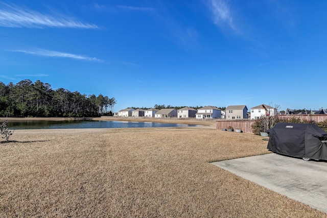 view of yard featuring a patio and a water view