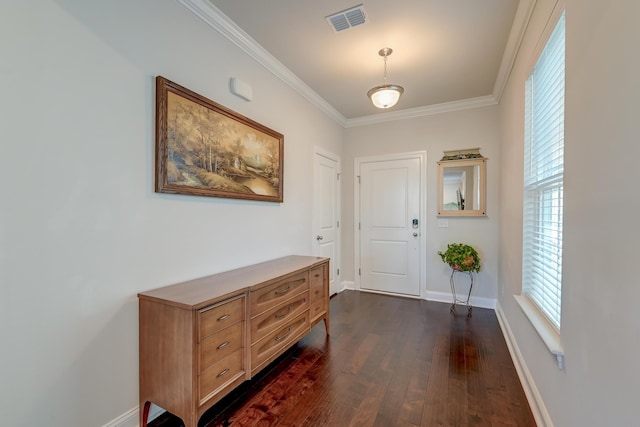 foyer entrance featuring crown molding and dark hardwood / wood-style floors