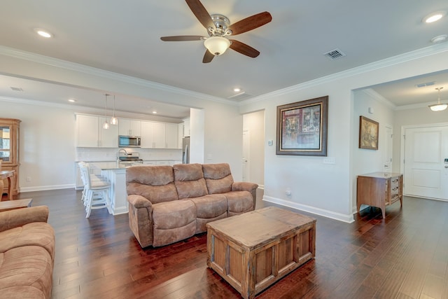 living room featuring ornamental molding, dark hardwood / wood-style floors, and ceiling fan