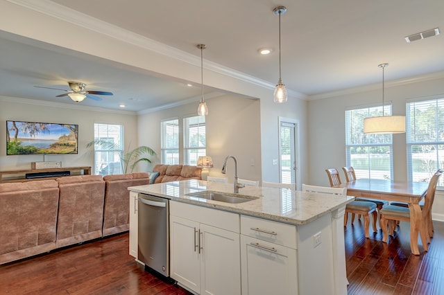 kitchen featuring dishwasher, sink, white cabinets, hanging light fixtures, and light stone countertops