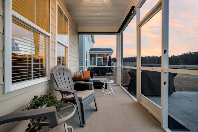 sunroom / solarium featuring ceiling fan