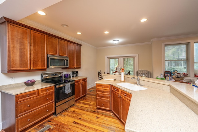 3005 Macbeth Creek Dr, Charleston, SC 29414 - kitchen featuring appliances with stainless steel finishes, light wood-style flooring, crown molding, light countertops, and recessed lighting
