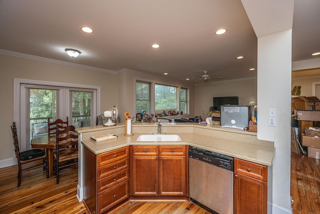 3005 Macbeth Creek Dr, Charleston, SC 29414 - kitchen with stainless steel dishwasher, crown molding, light countertops, light wood finished floors, and recessed lighting