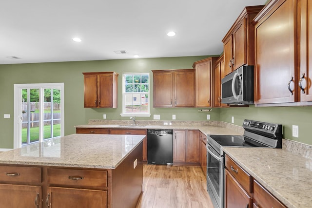 127 Rawlins Dr, Summerville, SC 29485 - kitchen with stainless steel appliances, plenty of natural light, a kitchen island, brown cabinetry, and recessed lighting