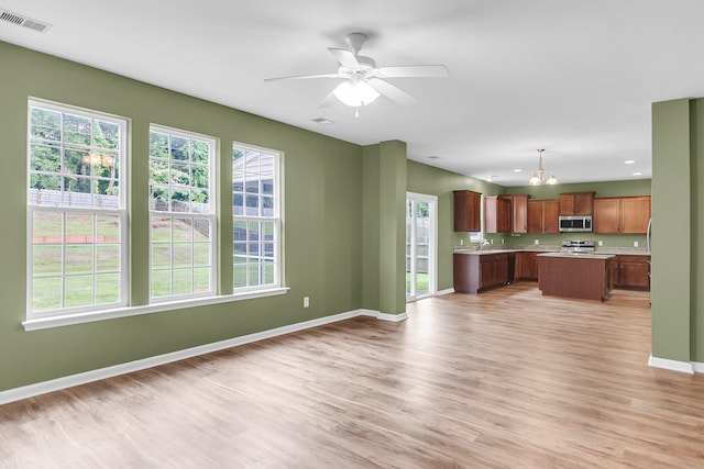 127 Rawlins Dr, Summerville, SC 29485 - kitchen featuring stainless steel appliances, light countertops, light wood-style floors, a center island, and recessed lighting