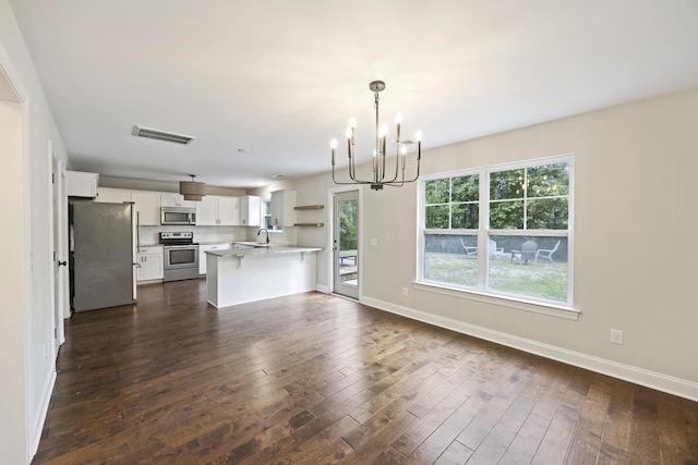 1506 Southwick Dr, Johns Island, SC 29455 - kitchen with stainless steel appliances, a peninsula, a chandelier, light countertops, and baseboards