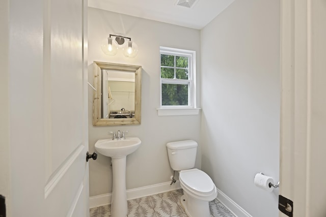 1506 Southwick Dr, Johns Island, SC 29455 - half bath with toilet, baseboards, tile patterned floors, and a sink