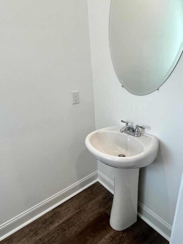 bathroom with wood-type flooring and sink