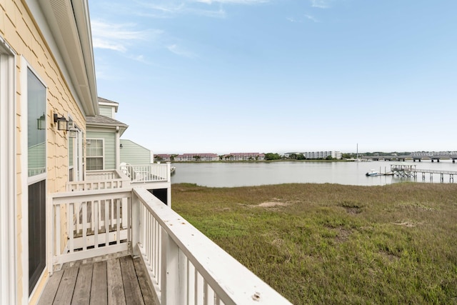 116 W 2nd St, Folly Beach, SC 29439 - wooden deck with a water view and a lawn
