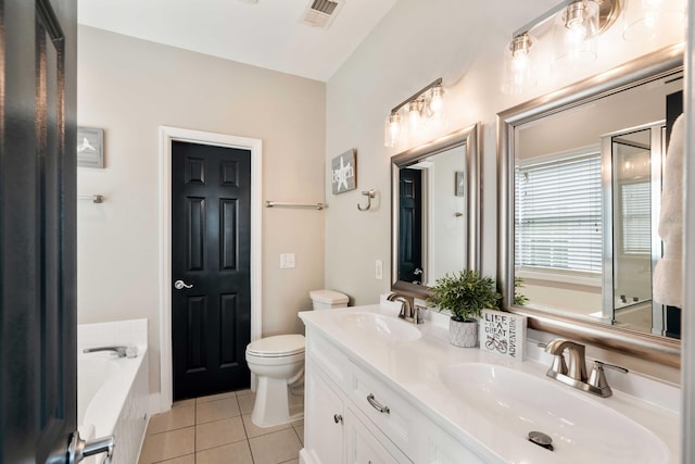 116 W 2nd St, Folly Beach, SC 29439 - full bath with tile patterned floors, toilet, a garden tub, and double vanity
