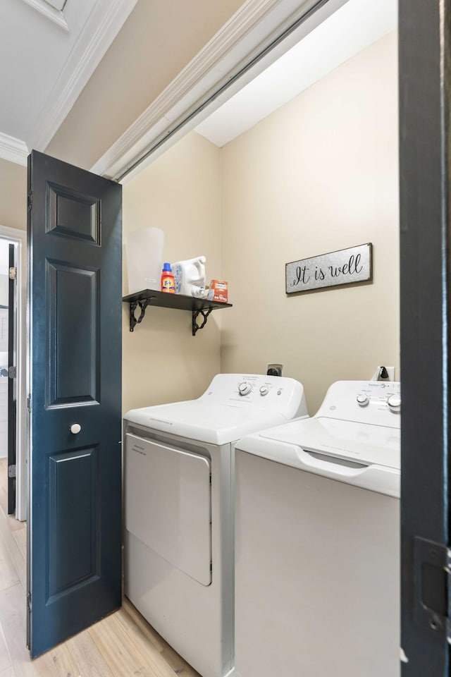 116 W 2nd St, Folly Beach, SC 29439 - washroom with separate washer and dryer, ornamental molding, and light wood finished floors