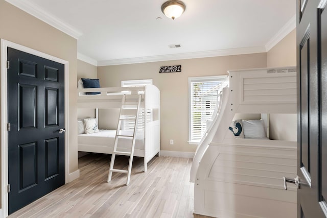 116 W 2nd St, Folly Beach, SC 29439 - bedroom featuring crown molding, wood finished floors, and baseboards